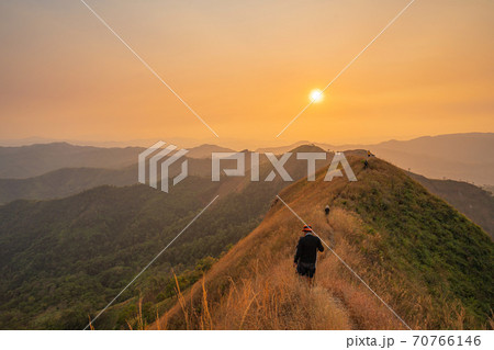 traveler man hiking enjoying in the mountains with backpack at Khao Chang Puak mountain Thailand 70766146