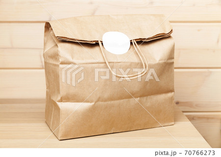 Full paper bag with white sticker 70766273