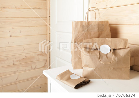 Paper bags with blank white stickers 70766274
