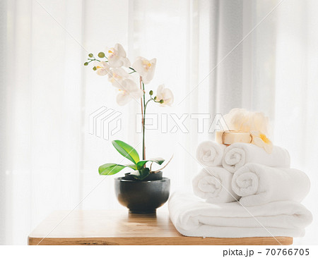 Spa products with white towels,soap,luffa scrub,comb and beautiful orchid flower in clean white room Spa products with white towels,soap,luffa scrub,comb and beautiful orchid flower in clean white room 70766705