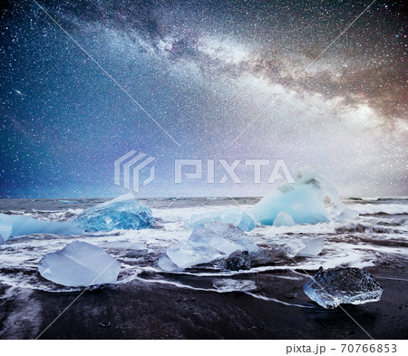 Icebergs floating in Jokulsarlon glacial lake. South Iceland. Lagoon. Starry sky night. Fantastic milky way. 70766853