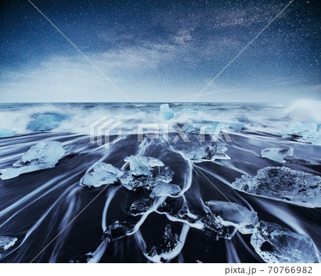 Icebergs floating in Jokulsarlon glacial lake. South Iceland. Lagoon. Starry sky night. Fantastic milky way. 70766982