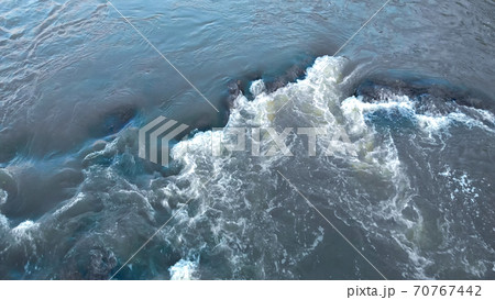 Aerial view of strong stream and flow of gray mountain river with stone Aerial view of strong stream and flow of gray mountain river with stone 70767442