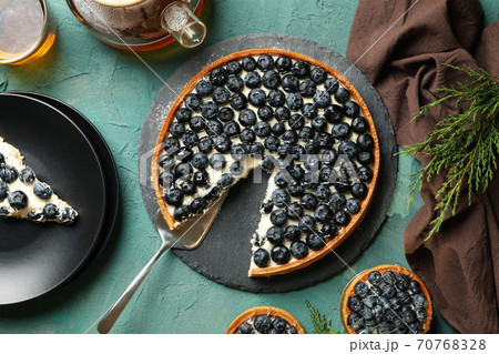 Concept of tasty lunch with blueberry pie on green background 70768328
