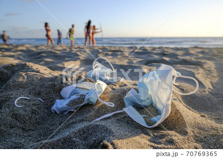 Medical waste,face mask discarded garbage,kids play on sea beach,covid19 virus pandemic pollution Medical waste,face mask discarded garbage,kids play on sea beach,covid19 virus pandemic pollution 70769365