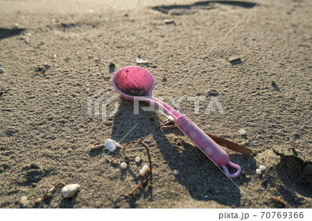 Plastic spoon kids toy discarded on dirty polluted sea ecosystem,planet pollution damage 70769366