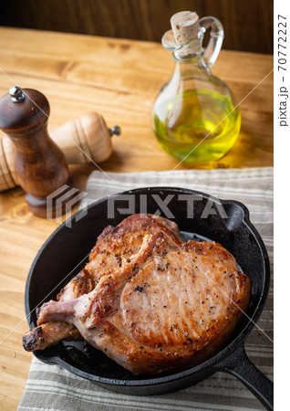 pan fried pork chop in skillet pan 70772227