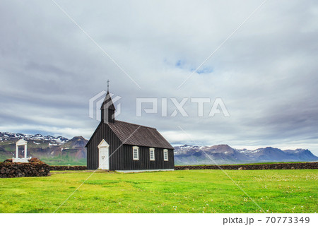 Mountain View Iceland. Beautiful black wooden church in Budir Mountain View Iceland. Beautiful black wooden church in Budir 70773349
