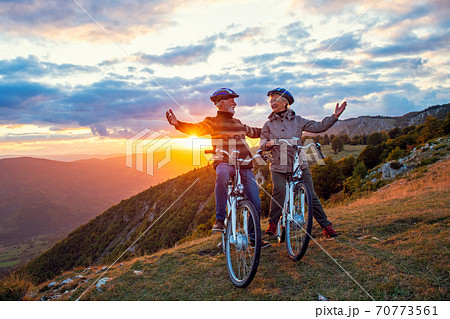 Happy senior couple on their bike. Bicycle, activity. Celebrating Happy senior couple on their bike. Bicycle, activity. Celebrating 70773561