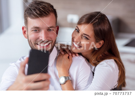 Happy Couple Taking Selfie In Mall Or Office Happy Couple Taking Selfie In Mall Or Office 70773737
