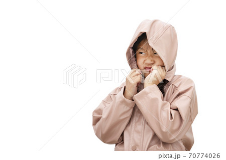 Happy little child woman angry face with a rain jacket isolated over in the white background, Copy space 70774026
