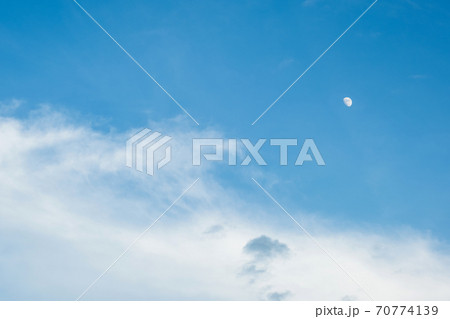 White clouds in the blue sky on a fine day and moon 70774139
