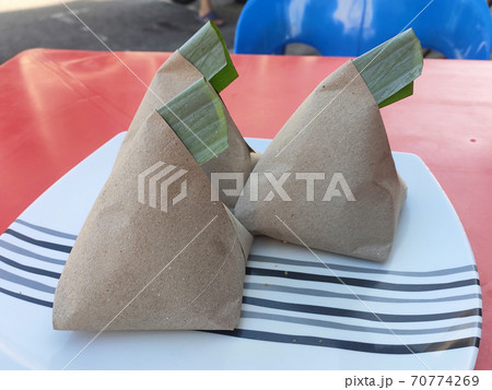 Nasi lemak. Is a signature food in Malaysia. Often eaten as breakfast. Nasi lemak is usually served with sambal, eggs and anchovies. 70774269