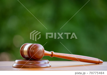 Old wood Judge hammer in close-up the table wood background, Used for adjudication and Justice. Old wood Judge hammer in close-up the table wood background, Used for adjudication and Justice. 70775464