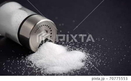 White sea salt for cooking in a small glass bottle. On the salt background, write stop. Concept for health 70775553