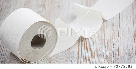 A large white toilet paper roll for use in bathrooms or kitchens, used for cleaning dirt in the bathroom background. A large white toilet paper roll for use in bathrooms or kitchens, used for cleaning dirt in the bathroom background. 70775592
