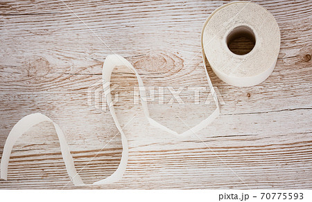 A large white toilet paper roll for use in bathrooms or kitchens, used for cleaning dirt in the bathroom background. 70775593