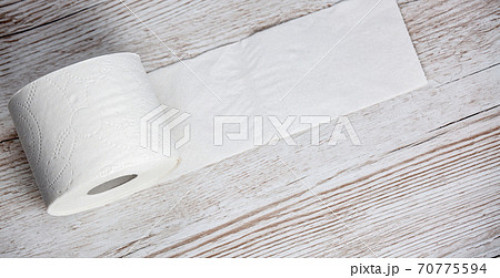 A large white toilet paper roll for use in bathrooms or kitchens, used for cleaning dirt in the bathroom background. 70775594