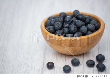 Bio Fruit Blueberry in bowl wood health and diet with vitamin c in close-up on the wood table. 70775613