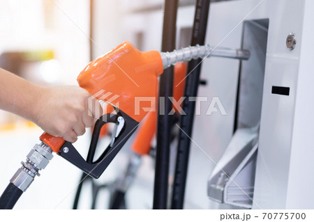 fuel pump nozzle closeup in gas station 70775700