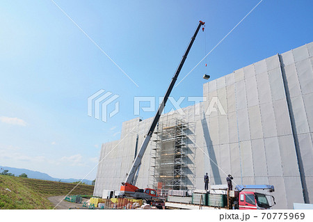 建築現場・クレーン車で資材を吊り上げ 70775969