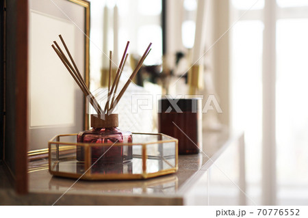 Aroma sticks with glass stand over bright background. 70776552