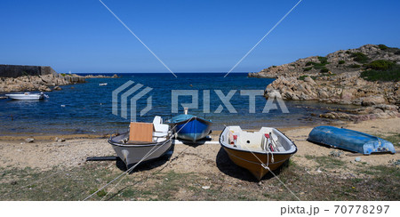 Panorama of fishing boats on the shore against the bay on a clear day 70778297