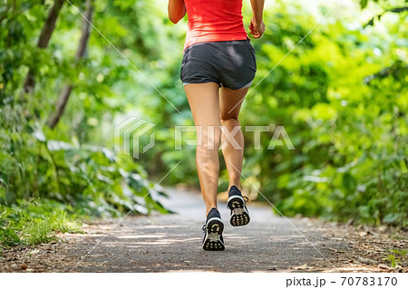 Runner running legs from the back jogging on nature path outside. Running shoes girl training cardio outdoors Runner running legs from the back jogging on nature path outside. Running shoes girl training cardio outdoors 70783170