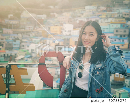 Young happy woman tourist in Gamcheon Culture Village, Busan, South Korea. Young happy woman tourist in Gamcheon Culture Village, Busan, South Korea. 70783275