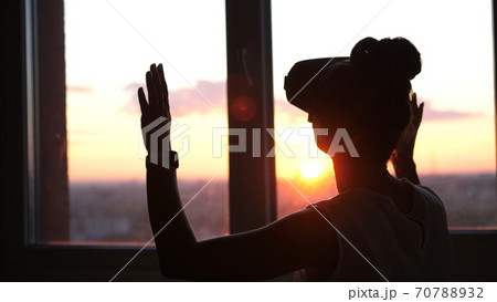 Technology VR-businessman young woman wearing virtual reality technology VR Glasses to work in modern office in a skyscraper. Technology VR-businessman young woman wearing virtual reality technology VR Glasses to work in modern office in a skyscraper. 70788932