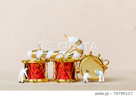 Miniature people,  Worker team painting a Christmas decoration 70790127