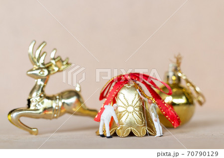 Miniature people,  Worker team painting a Christmas decoration 70790129