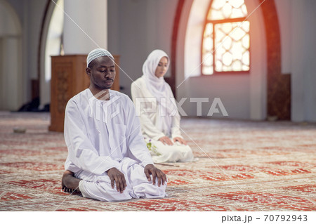 African Muslim Couple Praying inside of beutiful mosque African Muslim Couple Praying inside of beutiful mosque 70792943