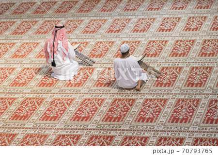 Two religious muslim man praying together inside the mosque 70793765
