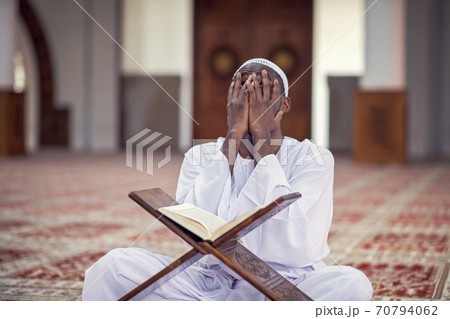 Religious black muslim man praying inside the mosque 70794062