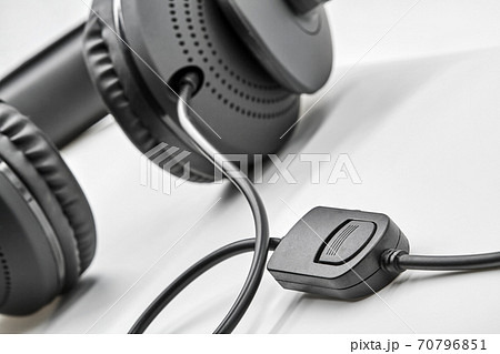 Remote Control from black headphones on white background. Closeup, selective focus Remote Control from black headphones on white background. Closeup, selective focus 70796851