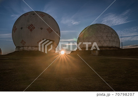 Dramatic sunrise over uniquely designed old radar station in shape of white spheres with red pattern Dramatic sunrise over uniquely designed old radar station in shape of white spheres with red pattern 70798207