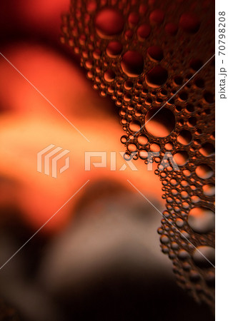 Crystal in red and yellow color water with bubble 70798208