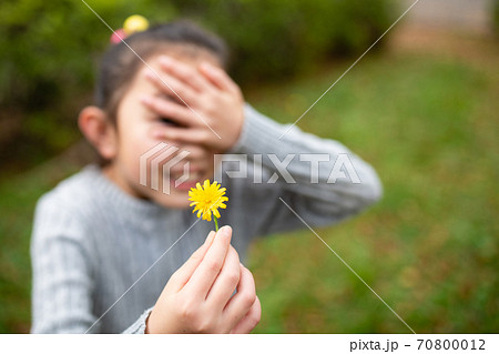 照れながら花を差し出す少女 70800012
