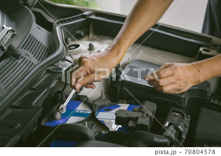 Engine engineer is replacing  car battery because car battery is depleted. 70804578