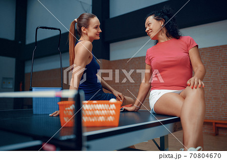 Women relaxing after table tennis match 70804670