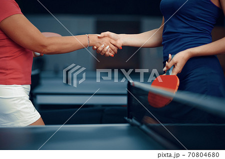 Women shake hands before table tennis match 70804680