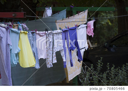 colored linen hangs on the clothesline outside and dries. The colorful south of Russia, summer 70805466