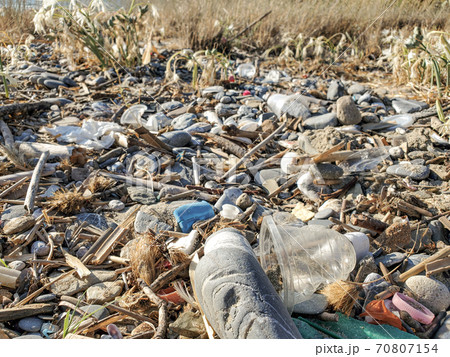 Disposable plastic dirty glass discarded waste,marine pollution,sea shore Disposable plastic dirty glass discarded waste,marine pollution,sea shore 70807154