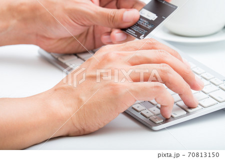 Person entering number of credit card with white 70813150