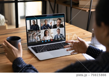Back view of woman talk on video call with colleagues Back view of woman talk on video call with colleagues 70815866