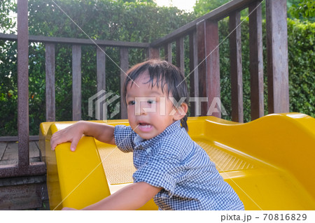 Little boy enjoying colorful playground park with slider 70816829