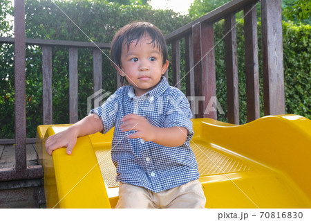 Little boy enjoying colorful playground park with slider 70816830