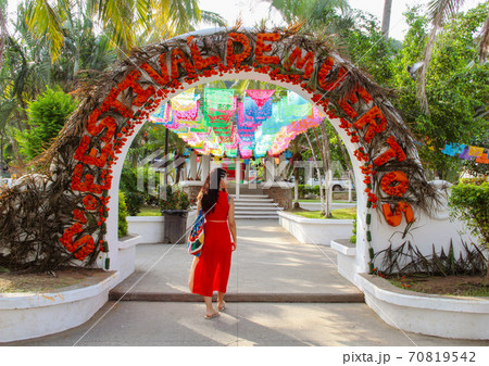 Woman at colorful street with palm trees in Sayulita, Nayarit, Mexico	 70819542