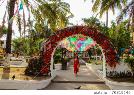 Woman at colorful street with palm trees in Sayulita, Nayarit, Mexico	 70819546
